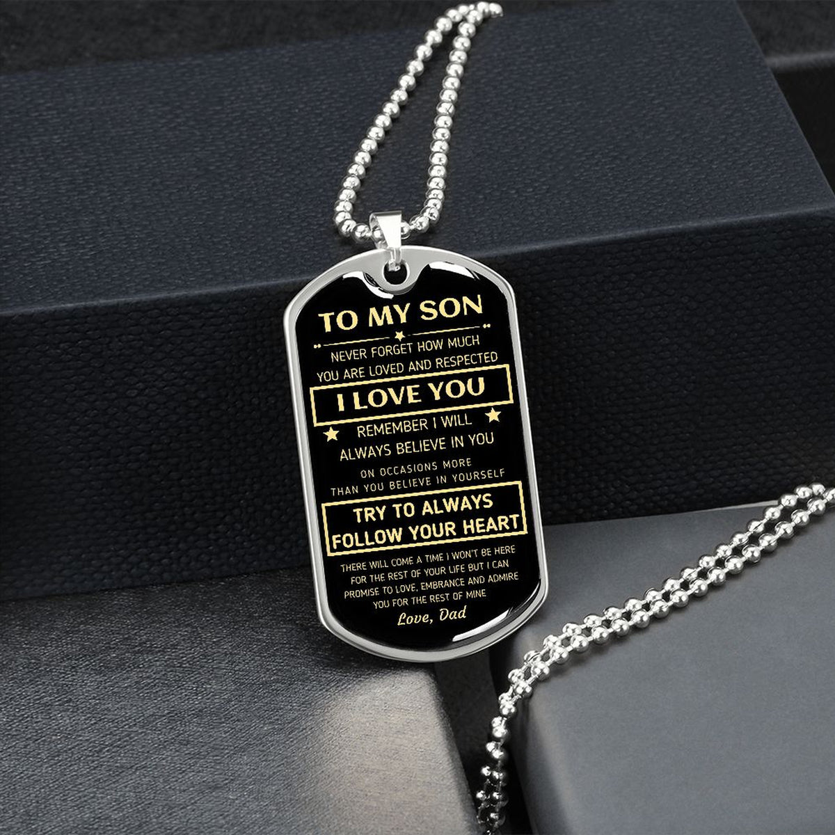 Silver To My Son dog tag hanging over a black gift box