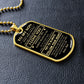 Gold-finish To My Son dog tag lying on black leather