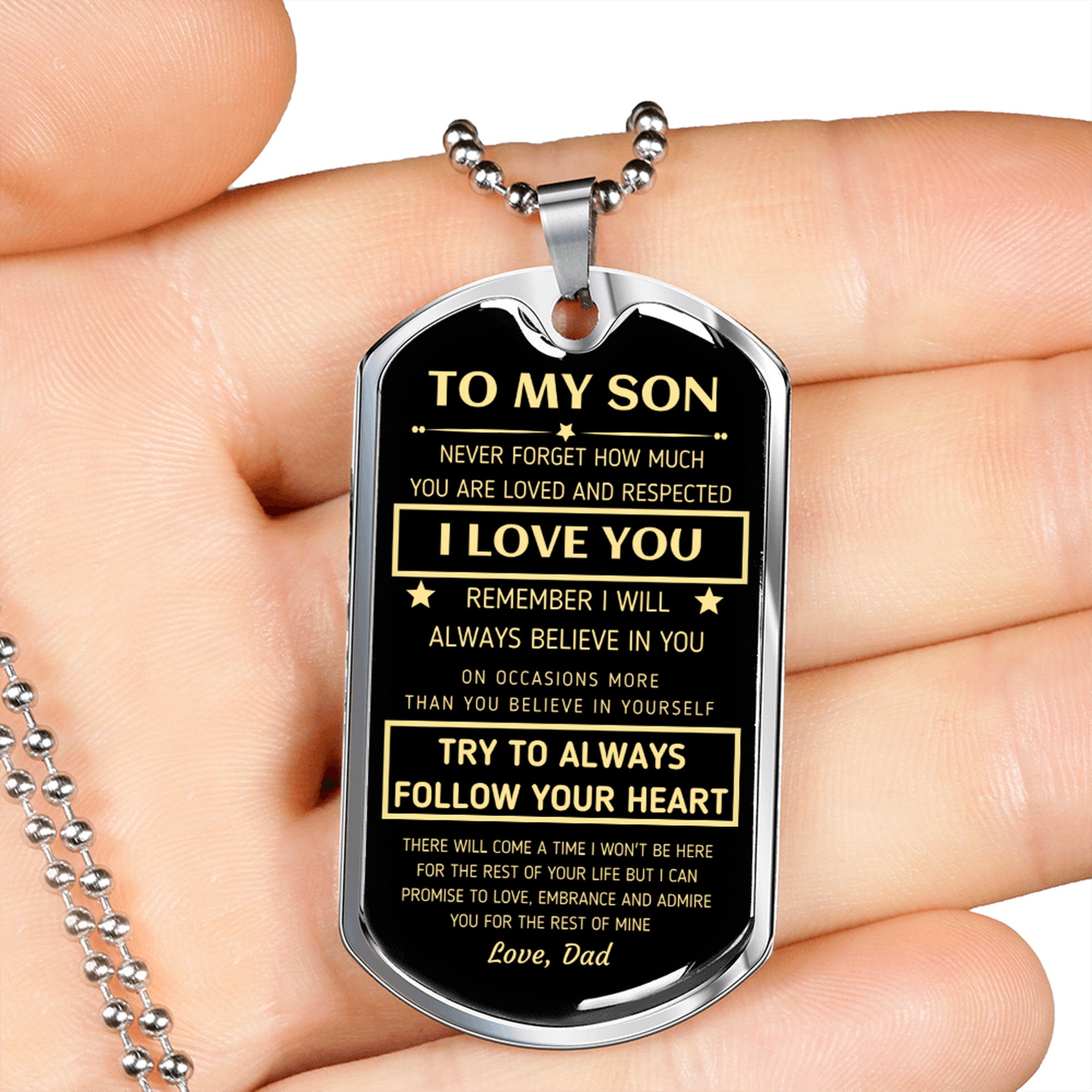 Silver To My Son dog tag held in an open hand