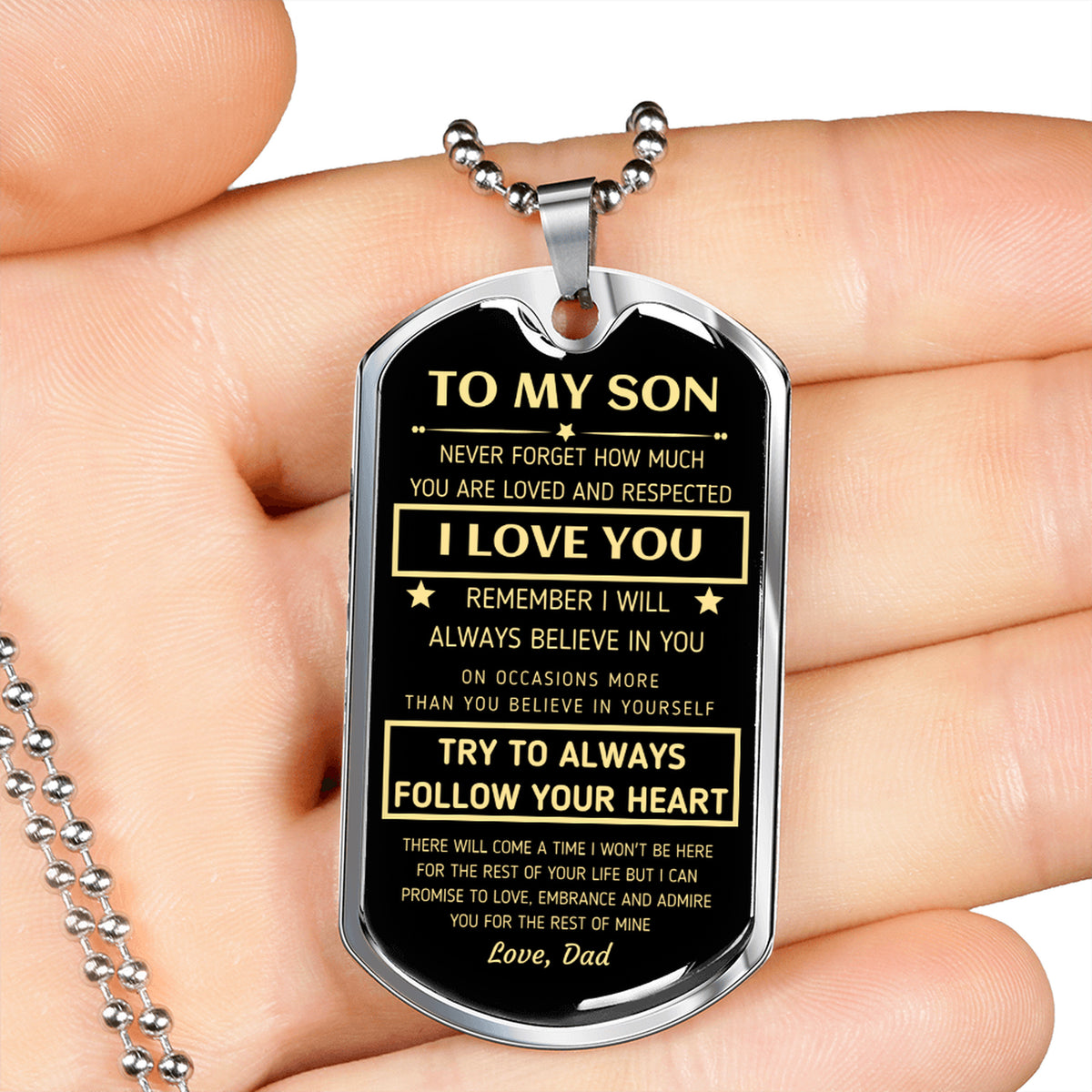 Silver To My Son dog tag held in an open hand