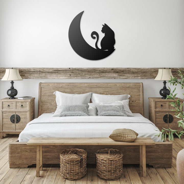 Black cat and crescent moon metal wall art above a bed